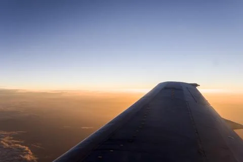 Nice sunset view on the wing of plane Stock Photos