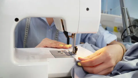 Nice tailor completing work with sewing machine at workplace. Stock Footage 87196129