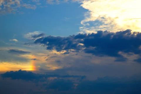 Nice twilight with rainbow between the clouds Stock Photos