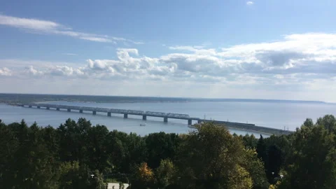 Nice view of the big bridge over the river. A train and cars move on it. The Stock Footage 115796224