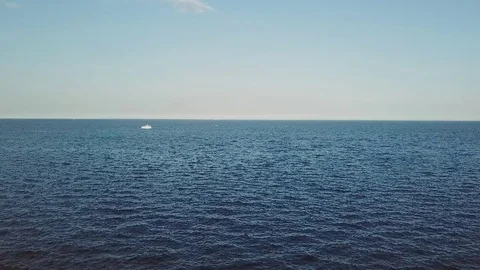 Nice view of a calm lake, a lonely boat at the middle of a blue lake Stock Footage 83529832