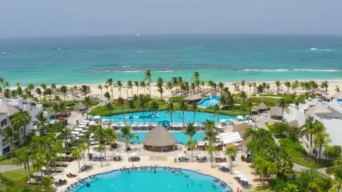 Nice view of the entertainment area with pools and restaurants by the white sand Stock Footage 159729504