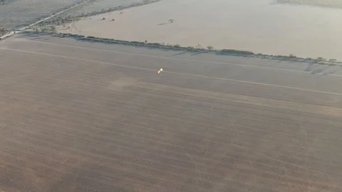 Nice view of powered paragliding flying over the broad drout empty crop Stock Footage 117129948