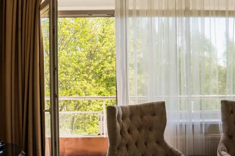 Nice view through window with comfortable chair. Stock Photos