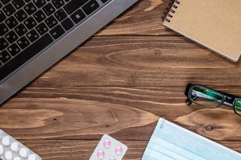 Nice wooden table with office objects on. Free space on the center, wallpaper Foto stock