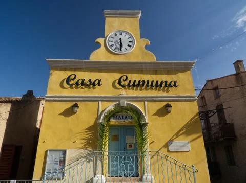Nice yellow facade of the tiny city hall in Cargese Stock Photos