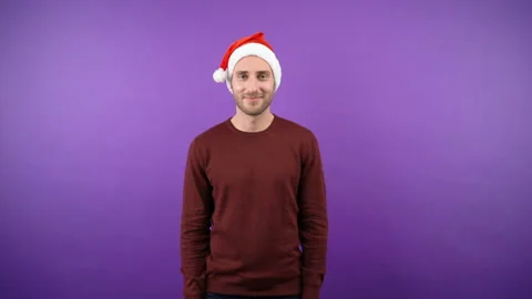 Nice young attractive bearded man in christmas santa hat man over isolated Stock Footage 142892984