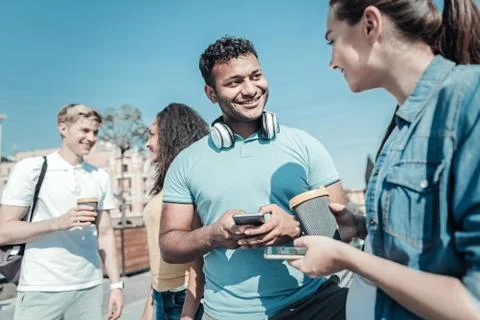 Nice young man using his smartphone Stock Photos