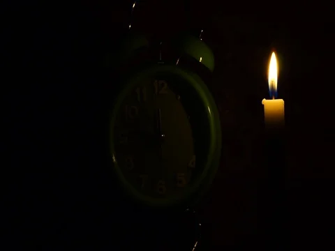 Nick of time by candlelight and clock ticking Stock Footage 82304275