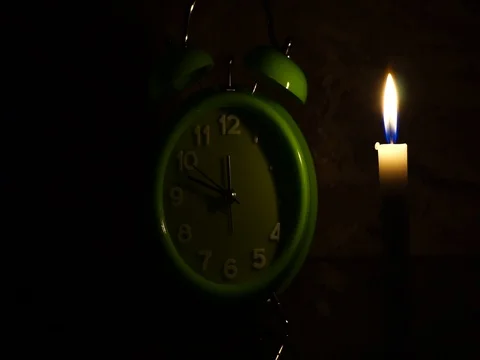 Nick of time by candlelight and clock ticking Stock Footage 82304288