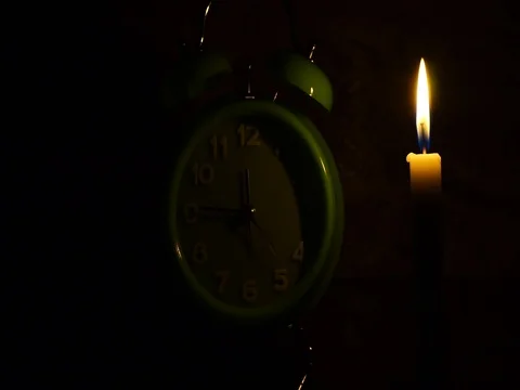 Nick of time by candlelight and clock ticking Stock Footage 82304289
