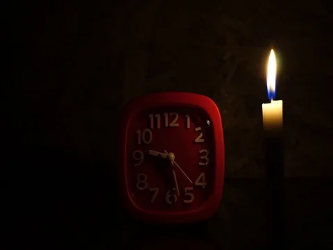 Nick of time by candlelight and clock ticking Stock Footage 82304381
