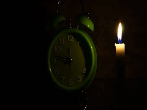 Nick of time by candlelight and clock ticking Stock Footage 82304404