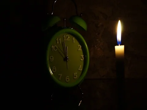 Nick of time by candlelight and clock ticking Stock Footage 82304560