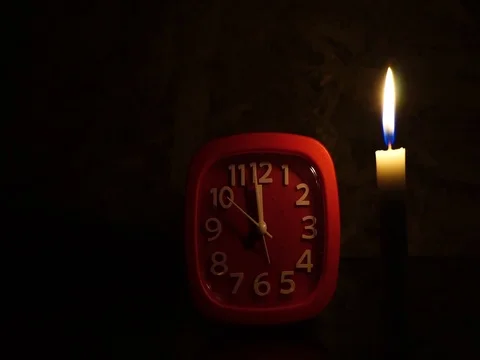 Nick of time by candlelight and clock ticking Stock Footage 82304562
