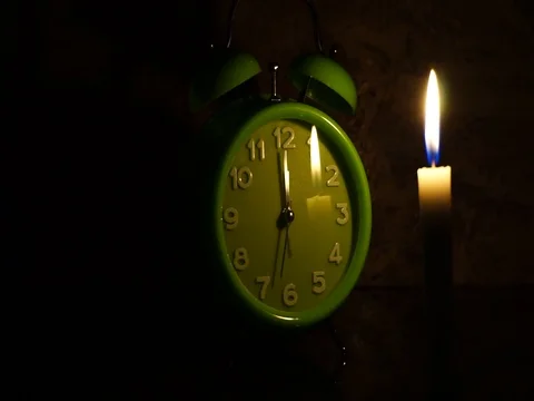 Nick of time by candlelight and clock ticking Stock Footage 82304636