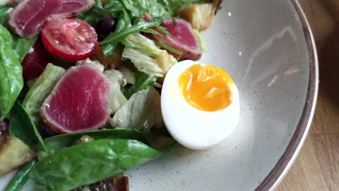 Nicoise salad on table Stock Footage 257959836