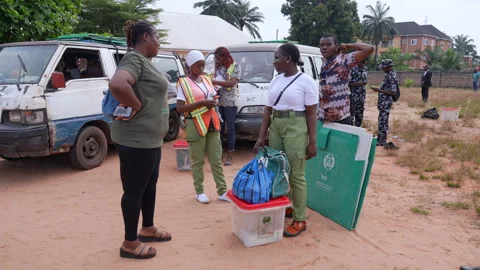 Nigerians voting during election in a poling unit and droping the vote inside Stock Footage 331424604