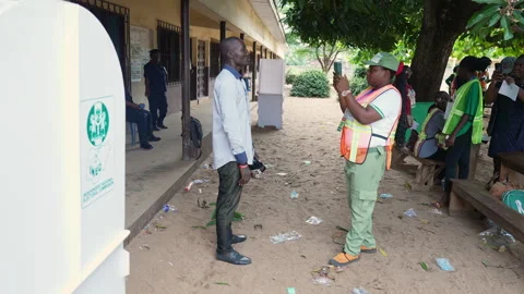 Nigerians voting during election in a poling unit and droping the vote inside Stock Footage 331424682
