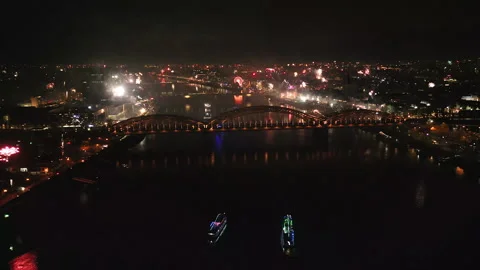 Night aerial of fireworks exploding over Cologne Skyline and Rhine river, Ge Stock Footage 326463780