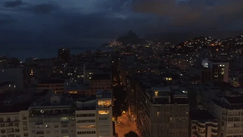 Night aerial moving towards Two Brothers mountain in Ipanema over buildings on Stock Footage 101286853