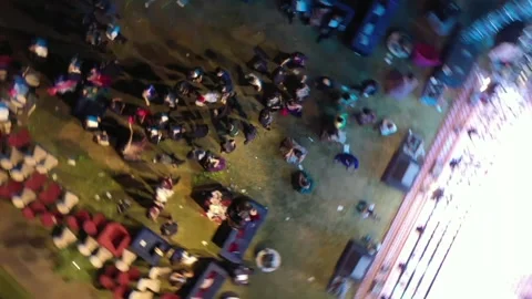 Night aerial rotating drone shot of people dancing at a Big Fat Indian Wedding Vídeo Stock 328815971