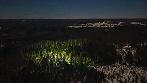 Night Aerial Time-Lapse of Illuminated Forestry Harvester Working in Dark Stock Footage 333032525