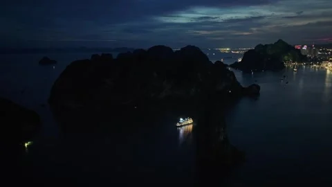 Night aerial view of limestone karst formations and coastal lights in Ha Long Ba Stock Footage 342691258