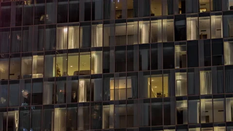 Night aerial view of office or apartment building glass window facade with Stock Footage 220131679