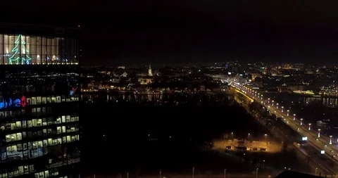 Night aerial view on skyscraper during holidays with decorated bridge Stock Footage