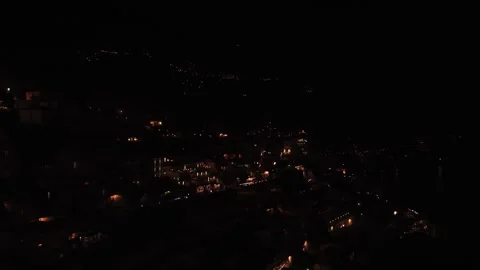 Night aerial view of a small mountain town with flickering street lights Stock Footage 340149780
