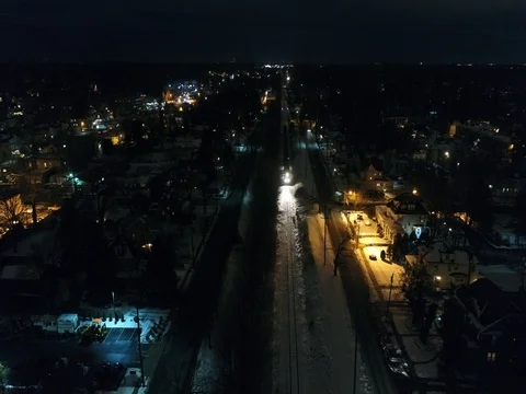 Night Aerial View of Westbound Train through Audubon and Oaklyn New Jersey Stock Footage 71409938