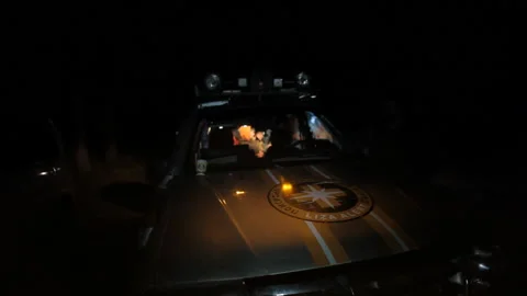 At night, the amber flasher is turned on at the patrol car of the volunteers of Stock Footage 166697996