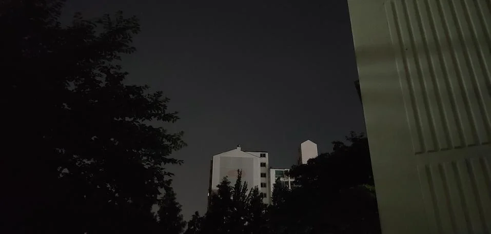 A night in an apartment complex with trees Stock Photos
