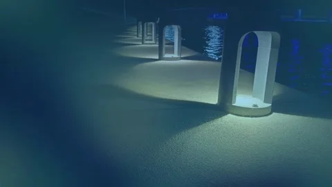 Night Architectural Arches with Blue Ambient Glow and Water Reflections Stock Footage 329464296