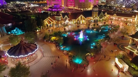 Night backlight Sochi theme park Russia castles carousel attraction People Drone Stock Footage 122226770
