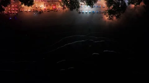 Night beach party with colored lights and gentle waves 스톡 동영상 305637693