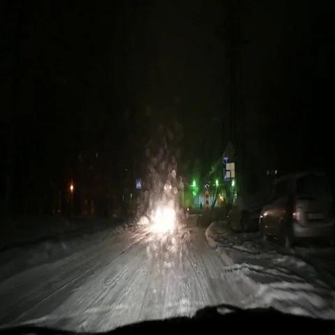 Night blizzard. Driving a car through snowbound roadcross. Stock Footage 69449824
