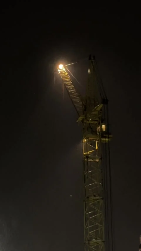 Night Blizzard Illuminated Construction Crane Video Stock Footage 328344374