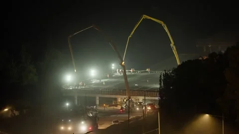 Night Bridge Construction and Concrete Pouring with Pump Cranes Stock Footage 342319213
