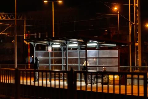 Night bus stop with waiting commuters Stock Photos
