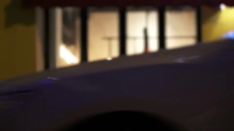 Night cafe through window from street with pedestrians and cars in night city. Stock Footage 68740804