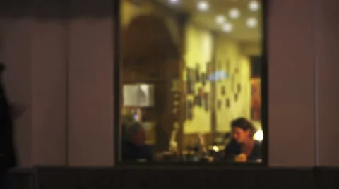 Night cafe through window from street with pedestrians in night city. Video stock 68752959