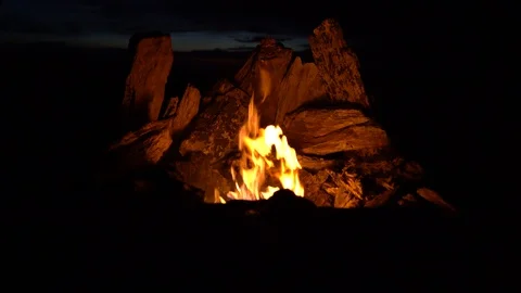 Night Campfire lined with stones, throw the firewood close-up Stock Footage 126982167