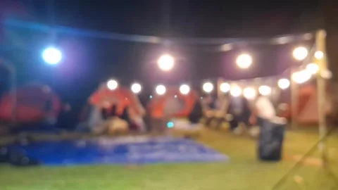 Night Camping Scene with String Lights and Blurred Tents Under Starry Sky Video stock 296937999