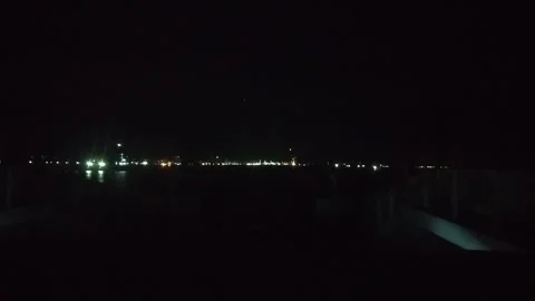 At night at the car ferry crossing port with the twinkling city lights Stock Footage 258810153
