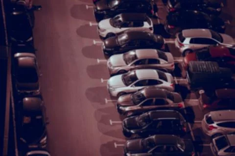Night car parking in rows, side view. Abstract blurred background. Stock Photos