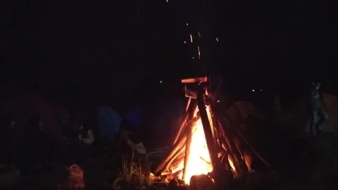 Night chating in front of bonfire campfire at donesian family fun camping at bro Stock Footage 151300531