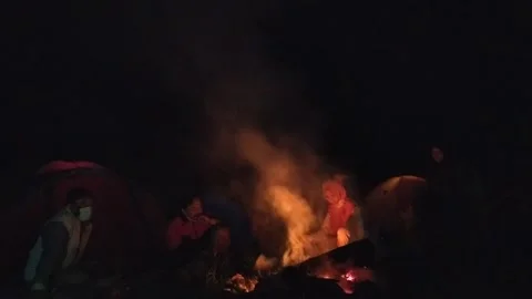 Night chating in front of bonfire campfire at donesian family fun camping at bro Video stock 151301856
