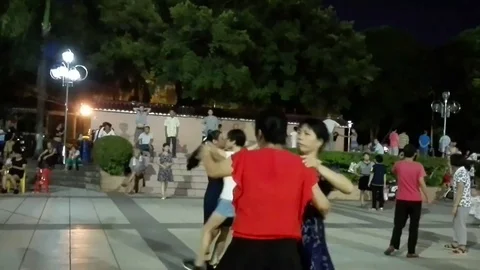 At night, Chinese women dance, play and entertain Stock Footage